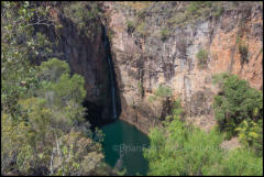 Tolmer Falls in Litchfield National Park. The caves behind are a breeding site for orange horseshoe and ghost bats.