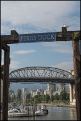 The old Ferry Dock on Granville Island and Burrard Bridge over False Creek in Downtown Vancouver.