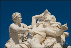 A sculpture of Proteus and Aristaeus in the formal gardens of the royal chateau in Versailles, France