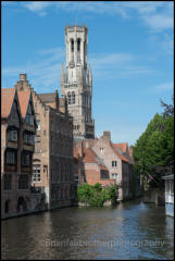 View from the Rozenhoedkaai and the Dijver Canal with the belfry in the background. Bruges, Belgium.