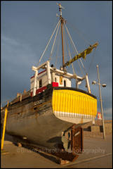 A fishing boat stored on the quayside at West Bay, Dorset.