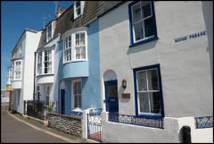 Colourful cottages along Nothe Parade in Weymouth, Dorset.