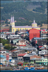 The city of Castro on Chiloé Island is famous for the colourful wooden stilt houses lining the waterfront and the yellow San Francisco Church, Chile.